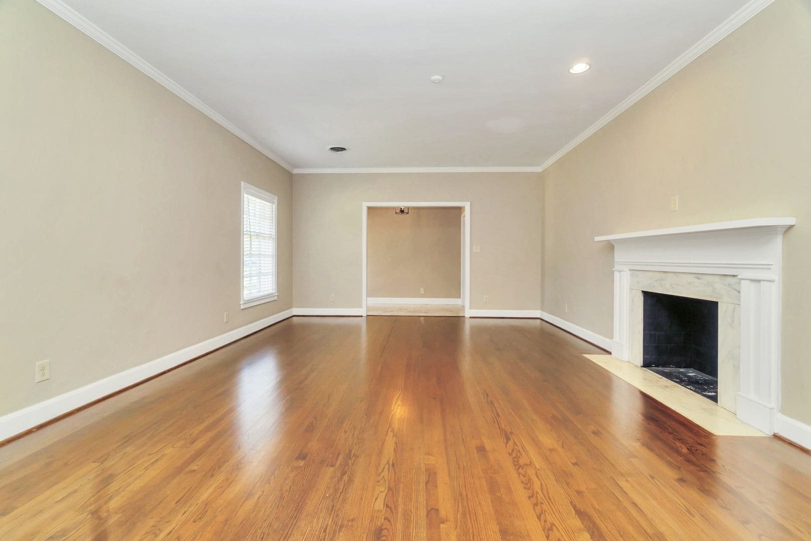 Empty living room with hardwood floors and fireplace